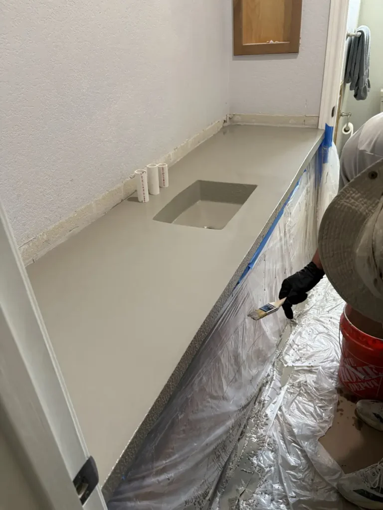 Bathroom concrete countertop with integrated sink being finished