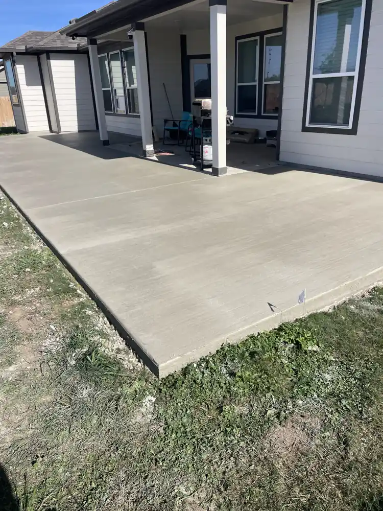 New concrete patio pour beside a house